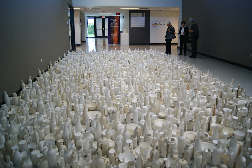 Visitors discussing the floor installation by Sung Young Kang.