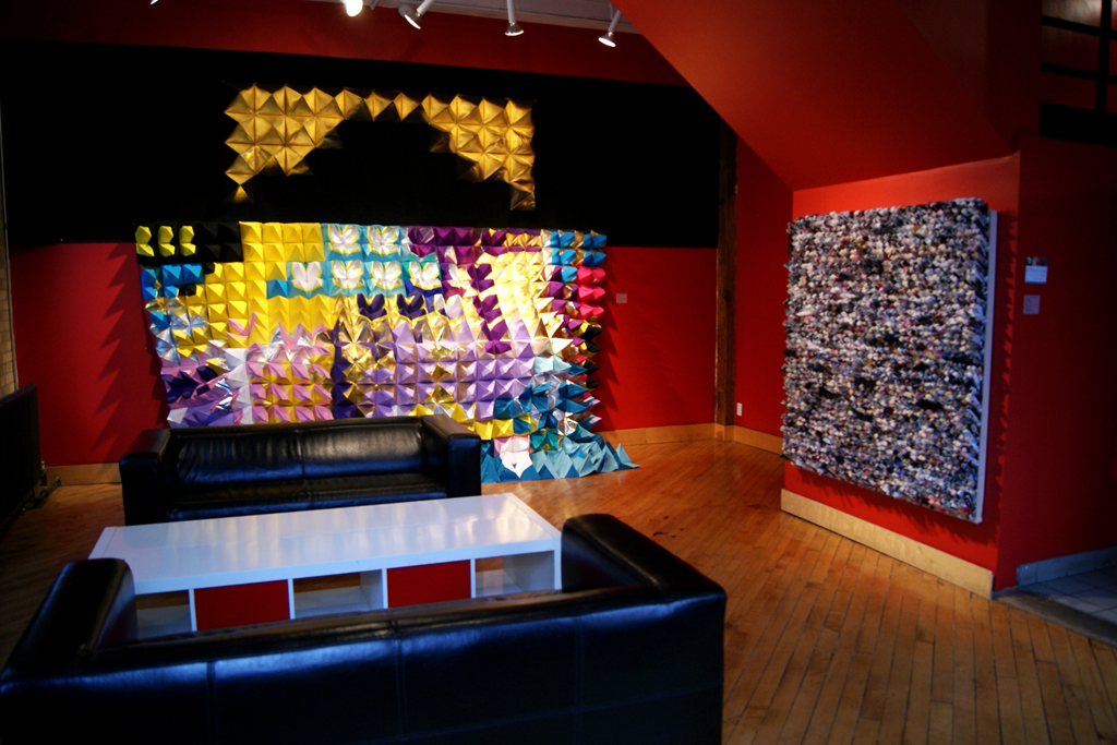 Polytopia (Reef), 2011, 100" tall x 140" wide, Post manufacturing industry and mill-end scrap textiles including canvass, upholstery, vinyl, nylon, foiled nylon wall covering, ripstop and waterproof fabrics, thread, staples.  Technique: Pyramids are sewn and assembled to each other by stapling.