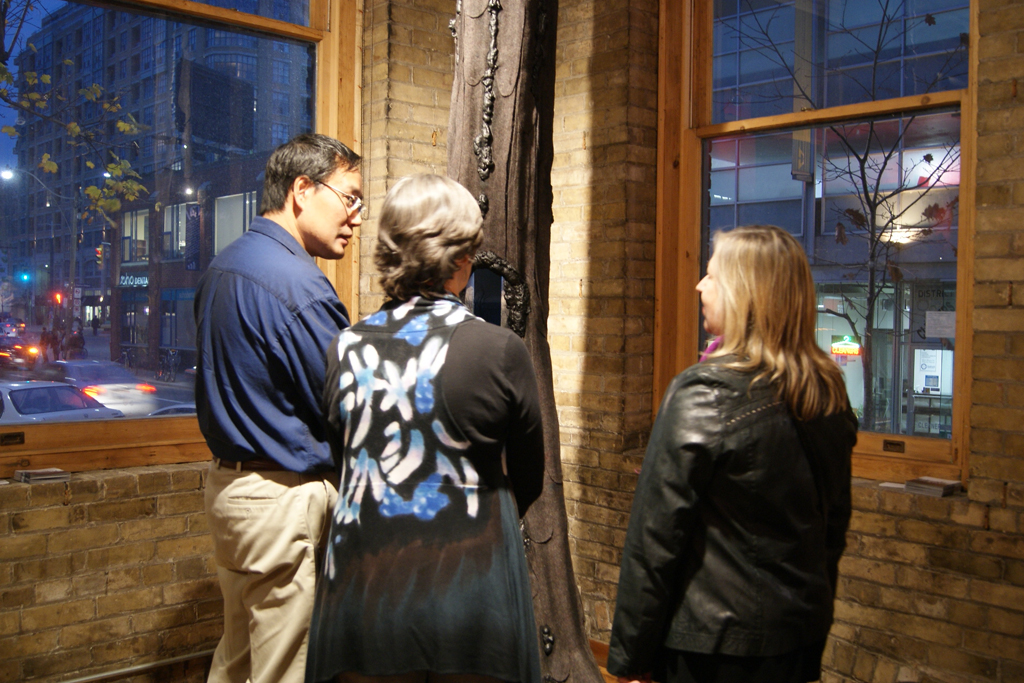 Artists and visitors gather for the exhibition opening.