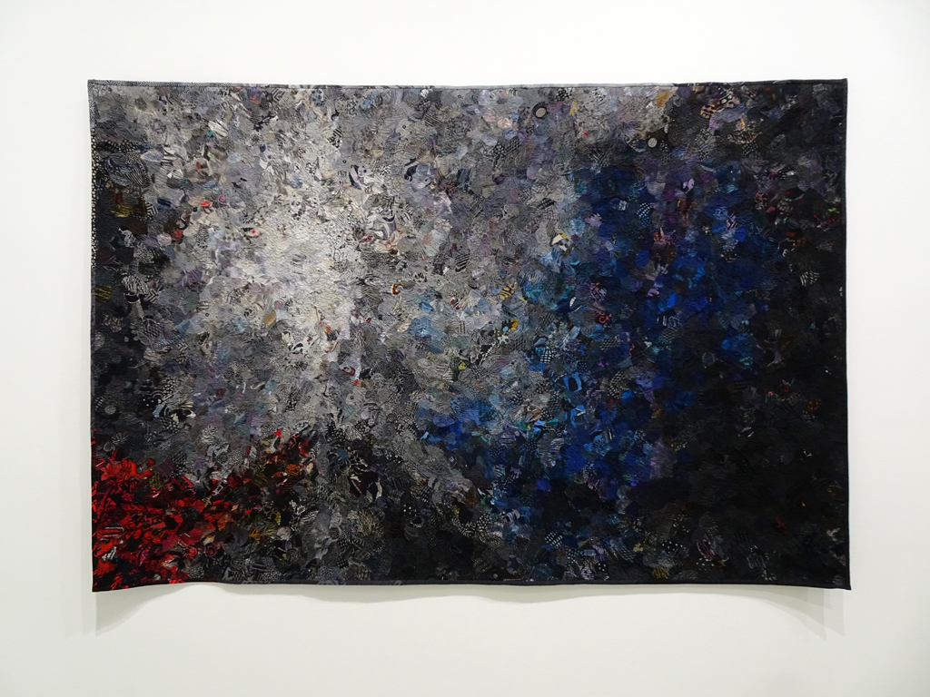 Helena Scheffer:  Black Crow Blues, 2016, (55” x 75”), commercial and artist-dyed cotton, silk, synthetic fabric, cotton, silk, polyester threads, cotton batting. Technique: collage, machine quilting. 