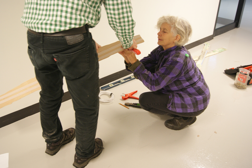 Jane LowBeer starting to install her work.