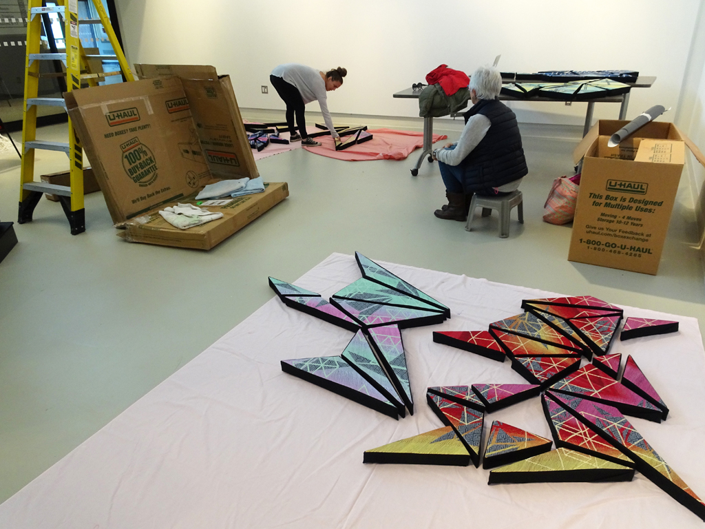 Artist: Heather Macali, Installing her artwork, World of Threads Festival 2016.