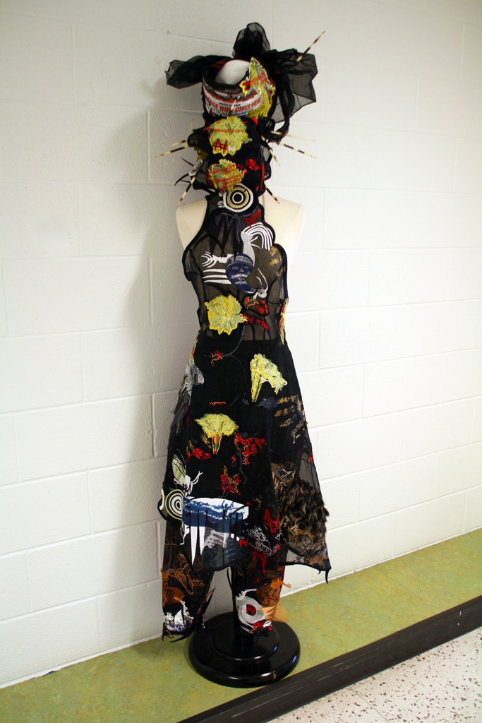 Nigerian Riot Girl 2015. Outfit to fit British size 10/12 industry standard, approx. 1.8m H x 40cm W x 40cm when displayed on mannequin. Medium: embroidery on cotton organdie. Porcupine Quills, applique fur and feathers, laser cut fabric. Technique: embroidery (including applique, laser cutting and 3D embroidery) and garment construction.