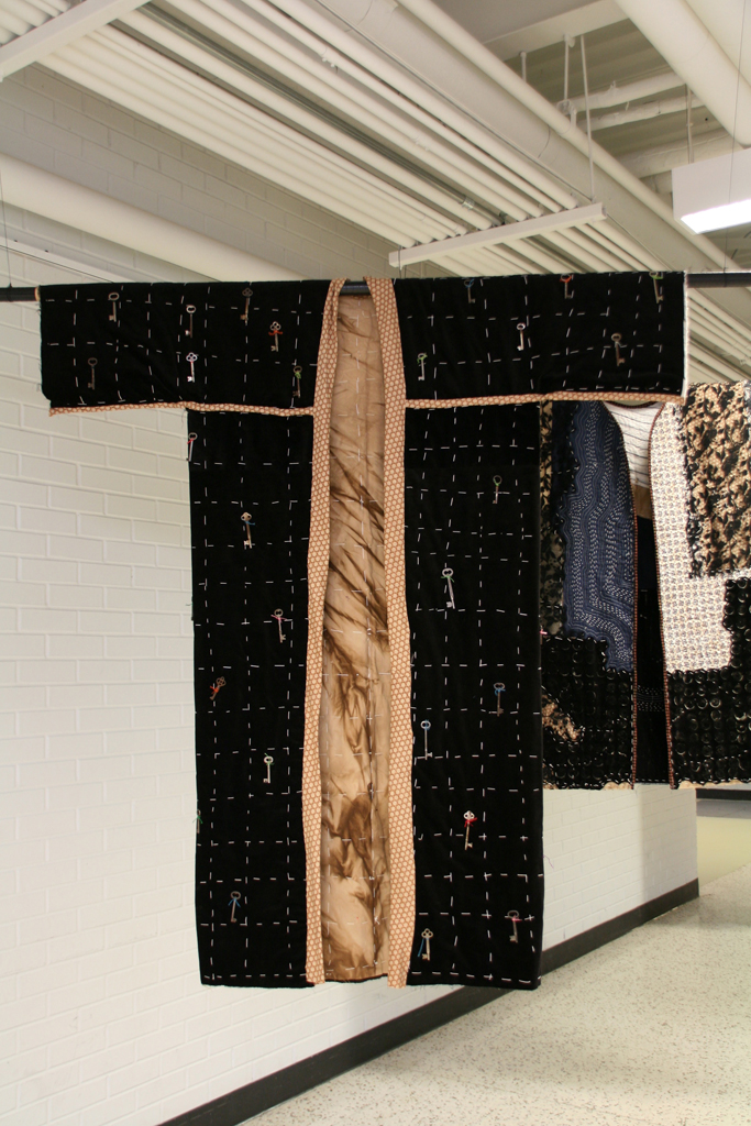 Untangled, 2015, 59”hx54”Wx1cmD, Black velvet, lined with walnut dyed cotton, stitched with cotton twine in a grid pattern, embellished with keys, attached with embroidery floss.