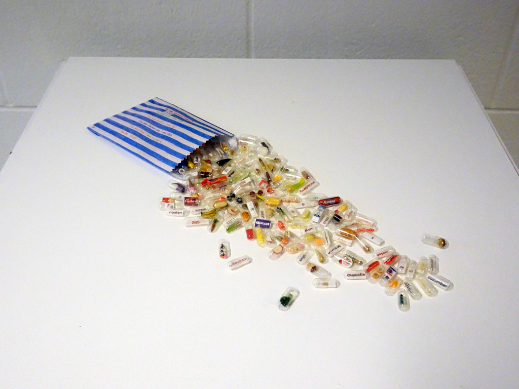 You see food I see numbers, 2016. Cotton bag, capsules, miniature objects, textile, silk threads. Hand stitch. Free standing.