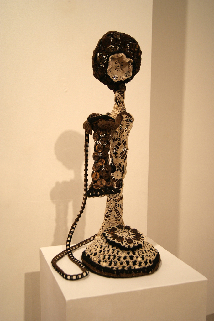 Charleston Queen, 2010
Materials: Antique and new cotton, buttons, artificial sinew, wire, synthetic felt, fibre-board base. Technique:	Crochet, button work, hand stitching, armature forming.