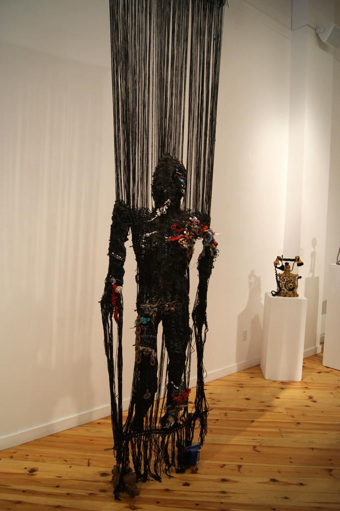 Woman with Two Vices
2011, Materials: Wool, wire, copper, chain, plastic, sisal, scrubbing pads, bolt, knife.
Technique: Tube weave.