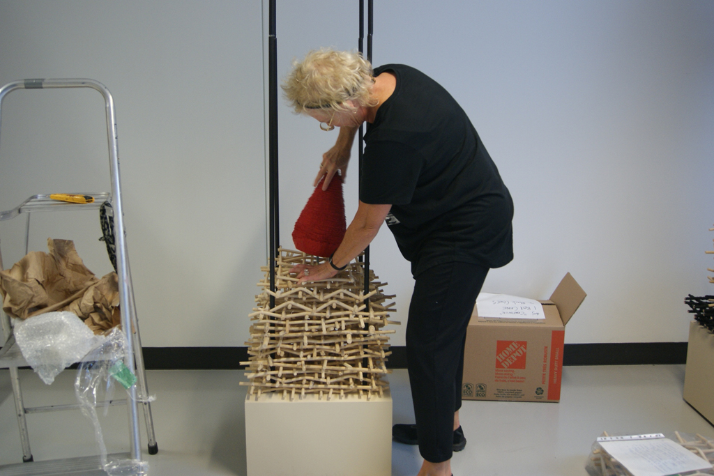 Eva Ennist installing her work, World of Threads Festival 2018.
