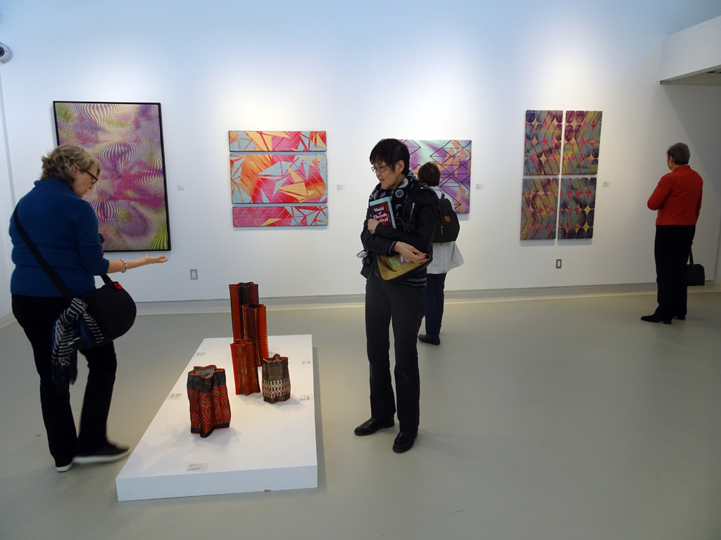 Visitors on an organized tour to the Cosmic Geometry exhibition, World of Threads Festival 2016.