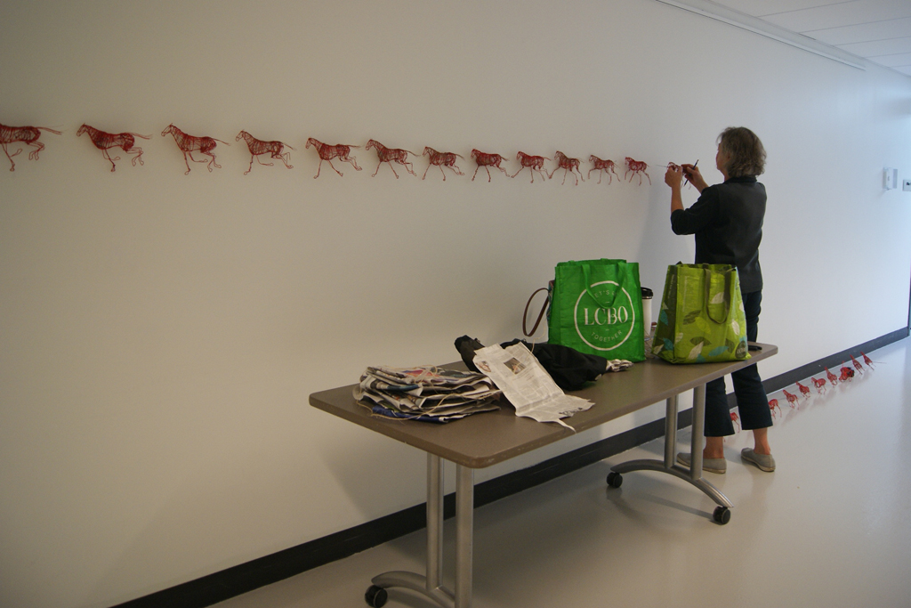 Anna Lefsrud installing her art installation.