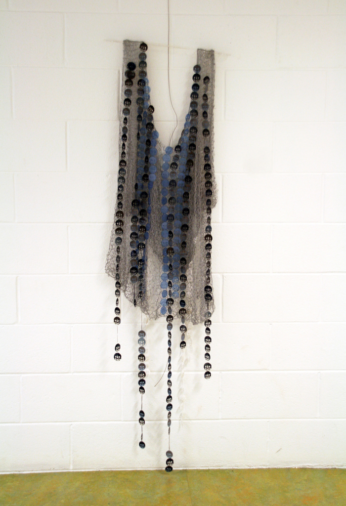 Women in War for Peace, 2015. Materials: X-Rays, reflective material and flat yarn of 1,5mm; nylon thread. Technique: Hand knitting, numerical treatment of tsubas for laser engraving and cutting on X-Rays; hand and machine sewing.Technique : X RAYS cut and sewn together with different kind of threads. Photo : Brigitte Amargar.