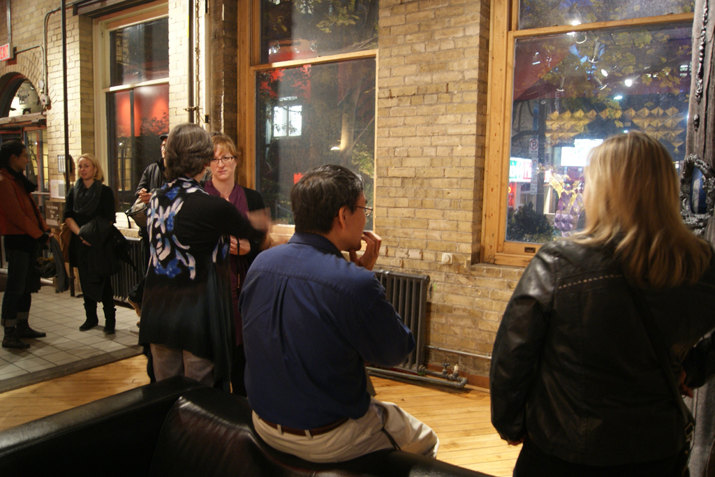 Artists and visitors gather for the exhibition opening.