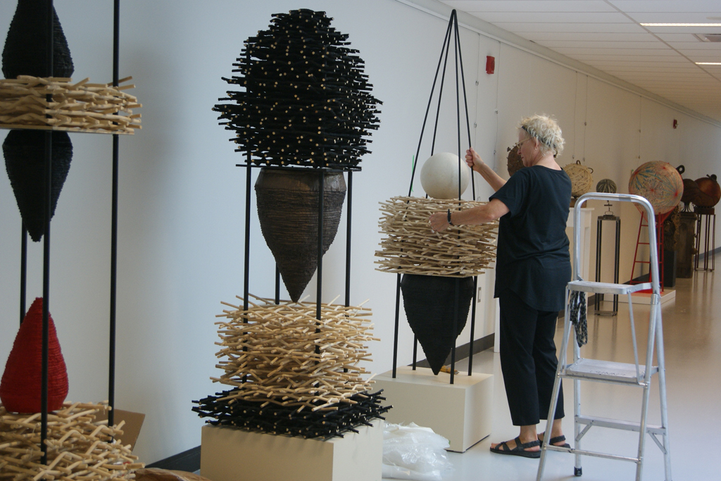 Eva Ennist installing her work, World of Threads Festival 2018.