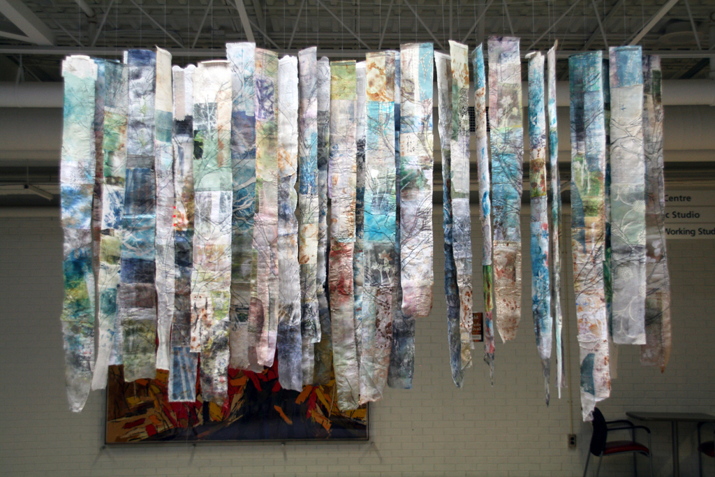 Cas Holmes: Trees, 2017, 20 pieces each 180H x 18-22 x 0.5D cm, cotton,  synthetics cloth and paper based found materials, printed with disperse dyes and acrylic paints, machine and hand stitched.