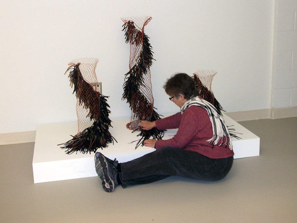 Colleen Lynch installing her artwork