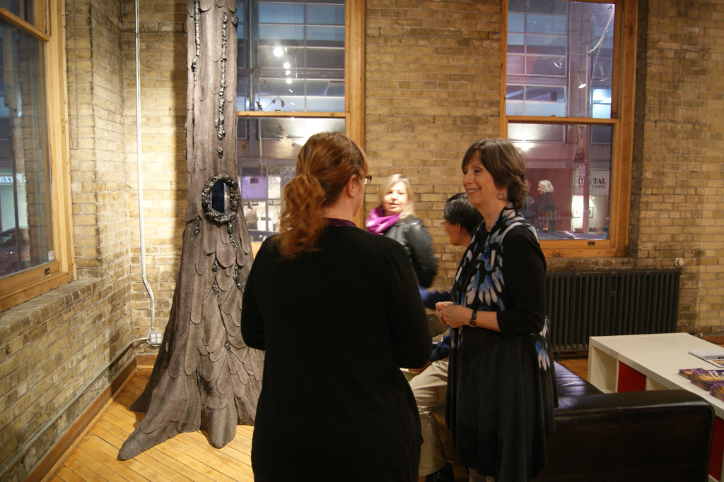 Artist, Lynn Kelly, chatting with visitors at the exhibition opening.