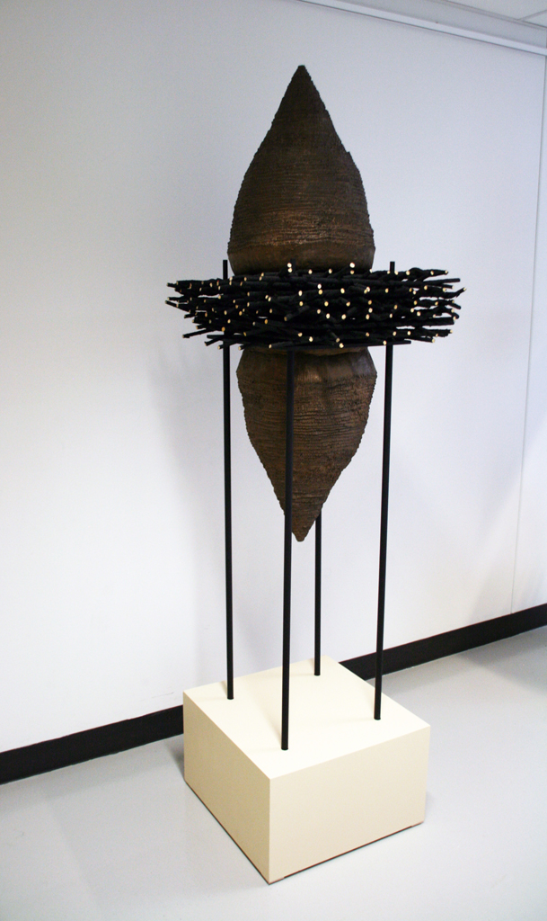 Eva Ennist: NESTING: Commit, 2017/18, 213.36 cm x 50.8cm x 50.8cm, reed, cold cast bronze, wood, steel, paint. Techniques: weaving, coiling, casting. Mounted on wood base.