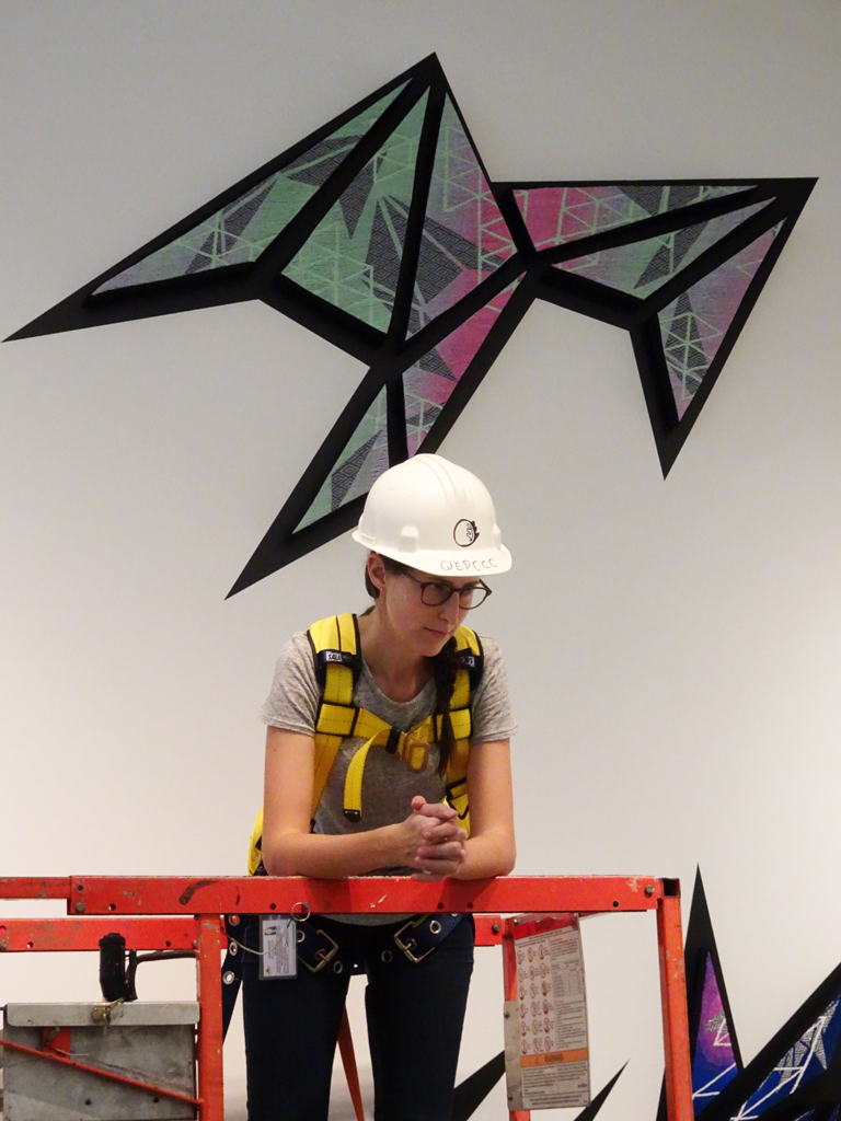 Installing artwork by Heather Macali, World of Threads Festival 2016.