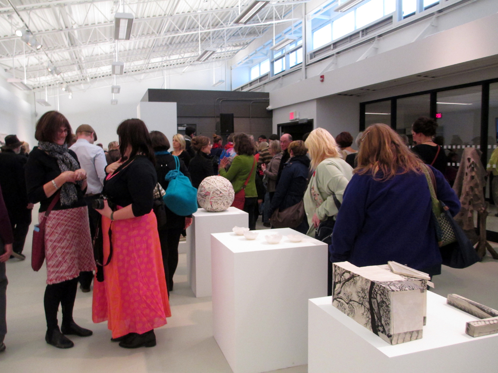 Artist Catherine Dormor chatting at the Quiet Zone exhibition, World of Threads Festival 2012vopening reception.