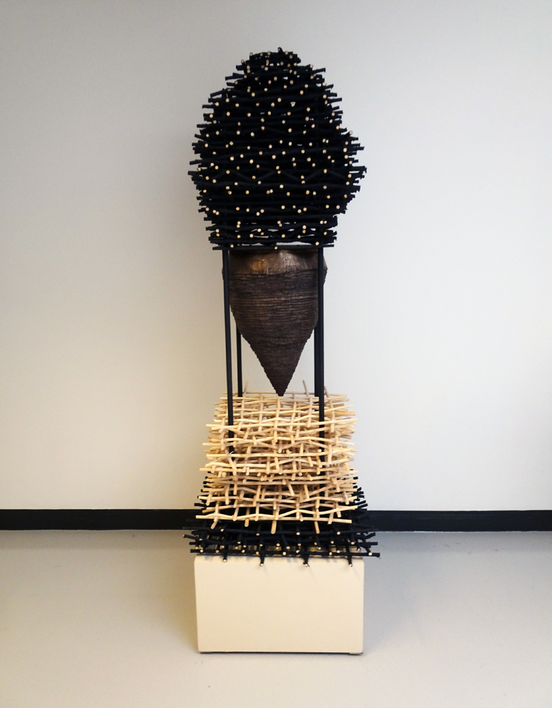 Eva Ennist: NESTING: tolerance, 2017/18, 195.5 cm x 54.25cm x 54.25cm, reed, cold cast bronze, wood, steel, paint. Techniques: weaving, coiling, casting. Mounted on wood base.
