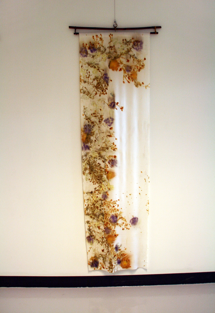 Linda Kollofski: Silk Charmeuse Coreopsis, 2017, 73H x 21W x .5D inches, woven silk charmeuse, flowers and leaves. Technique: Ecoprinted with plants from my garden using their natural dyes. Hung on bamboo hanger: 27W x 3H.