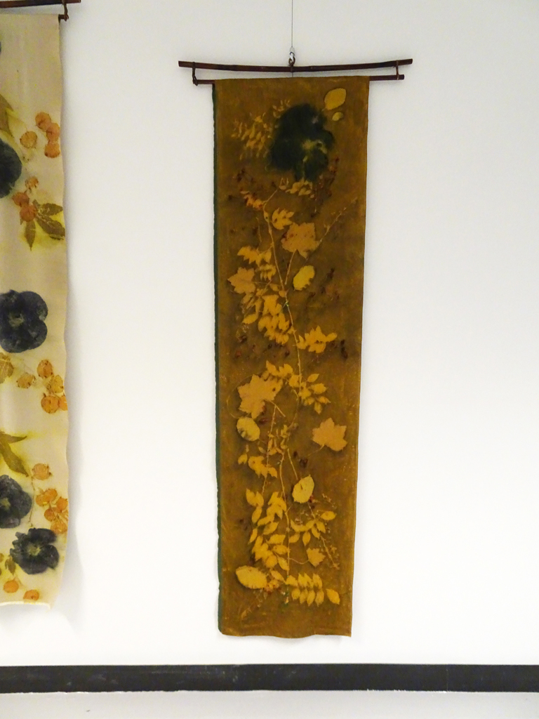 Linda Kollofski: Hibiscus Star, 2017, 71H x 19W x .5D inches, woven silk satin, flowers/leaves, and natural dye, beads. Technique: Ecoprinted with plants from my garden using their natural dyes. Hung on bamboo hanger: 27W x 3H.