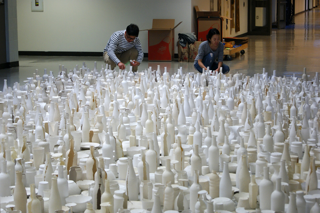 Sun Young Kang putting the finishing touches to her massive floor installation.