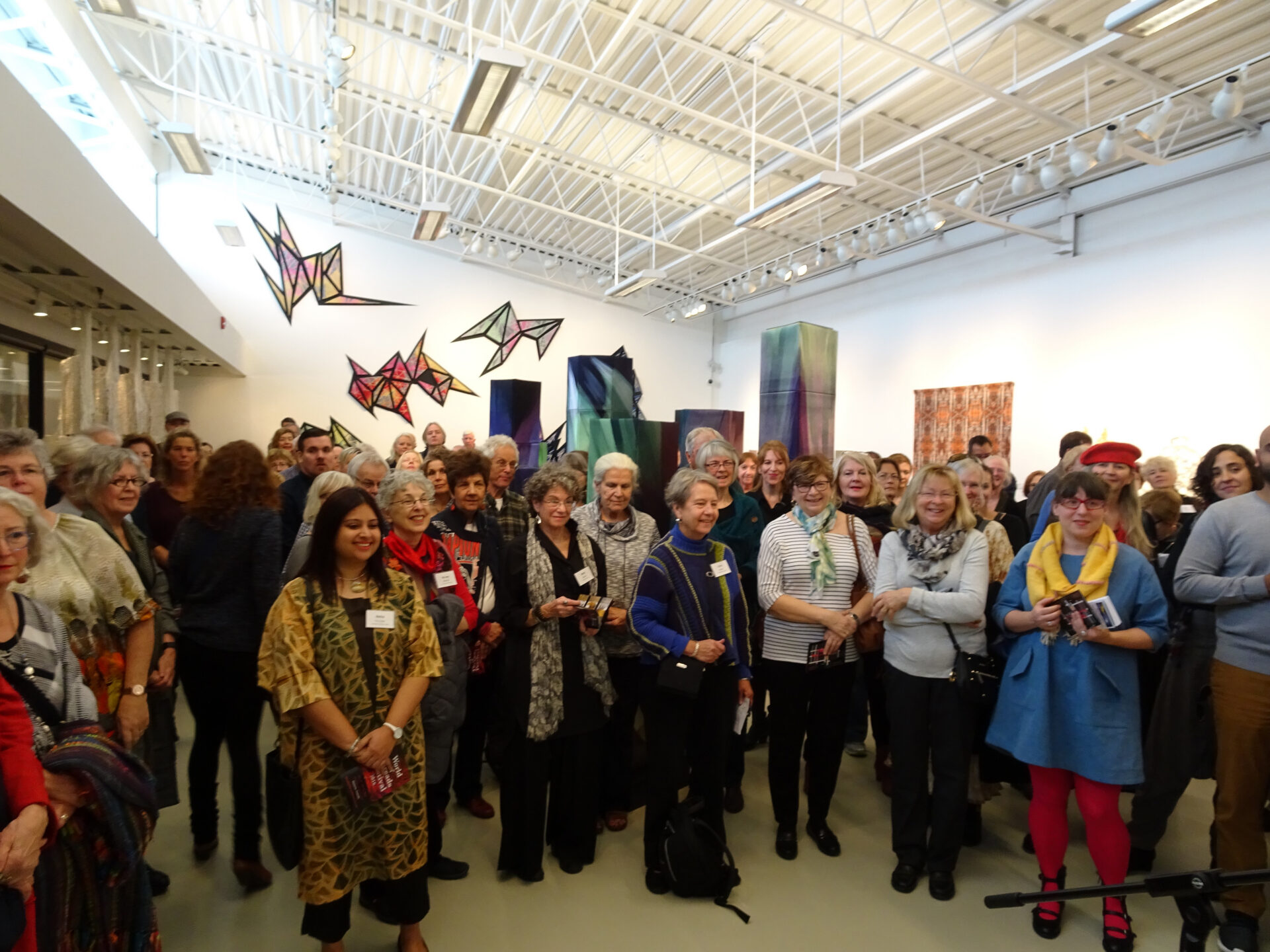 Artists and supporters gather for the opening reception of the Cosmic Geometry at World of Threads Festival 2016.