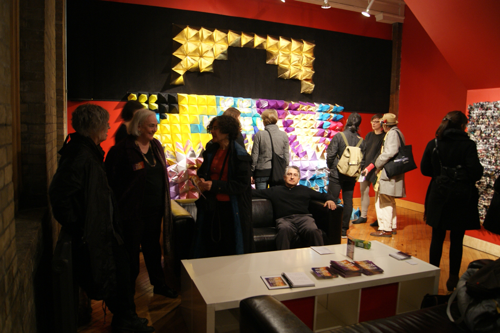 Artists and visitors gather for the exhibition opening.