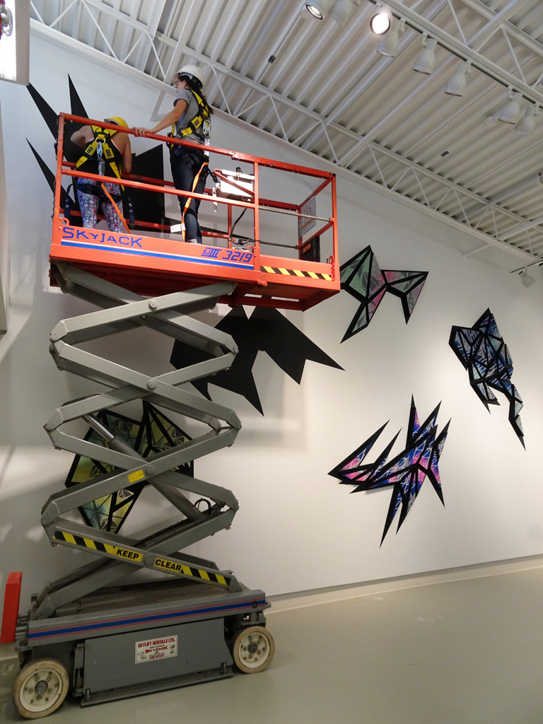 Installing artwork by Heather Macali, World of Threads Festival 2016.