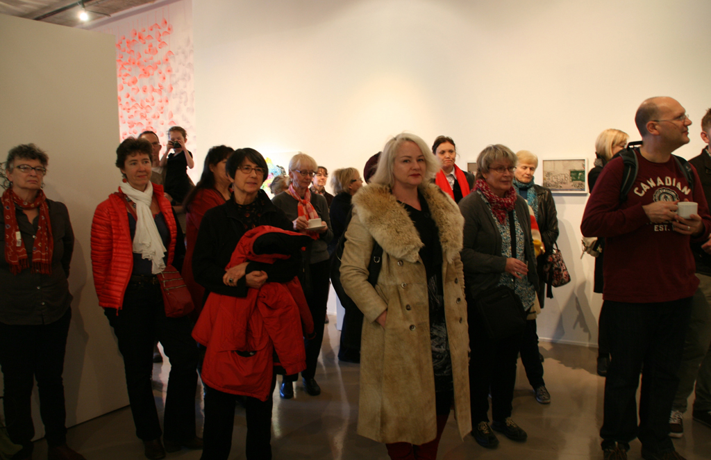 Artists and visitors gather at the opening, Strung out and Undone exhibition, World of Threads Festival 2014.