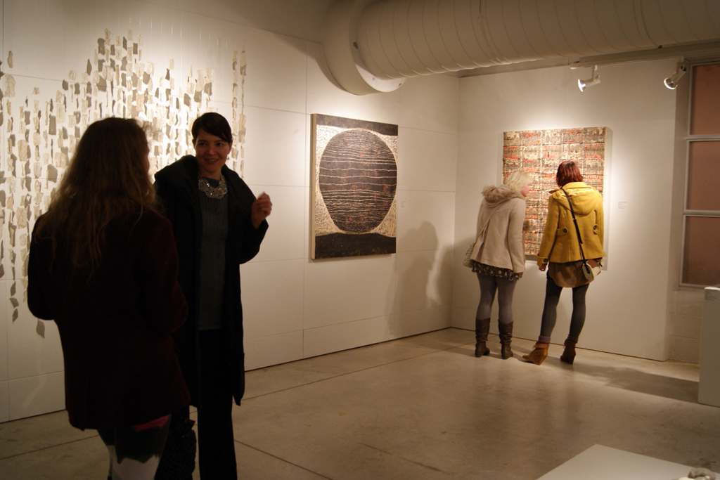 Artist Carrie Fisher chatting to a visitor.