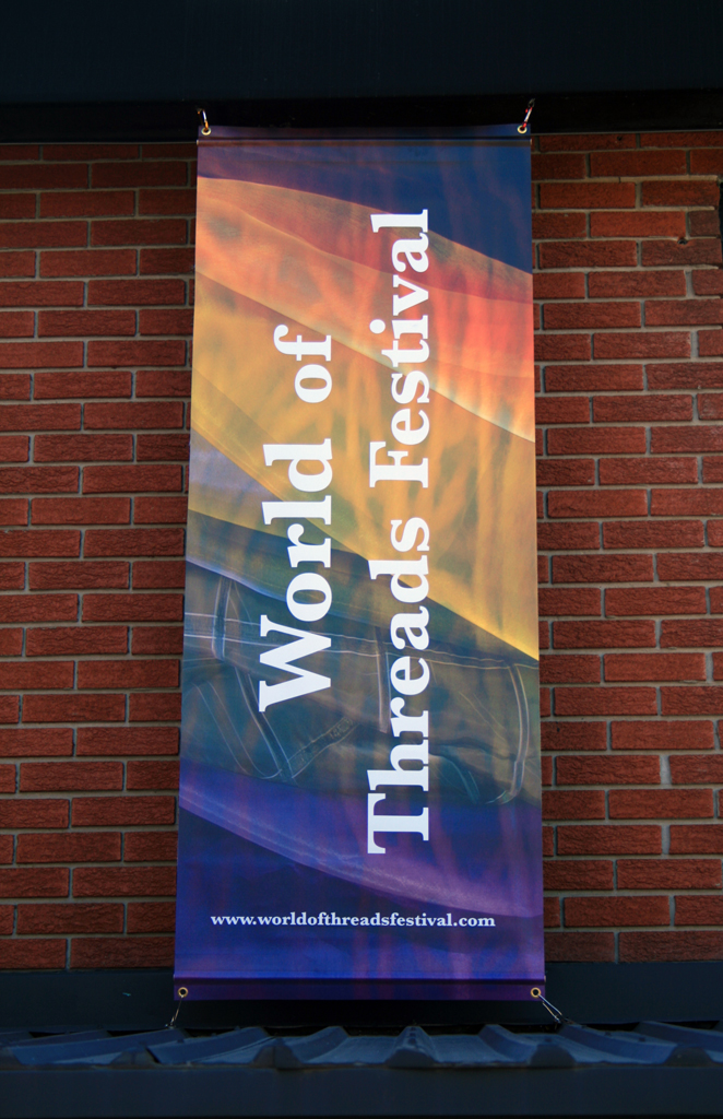 World of Threads Festival banner.
