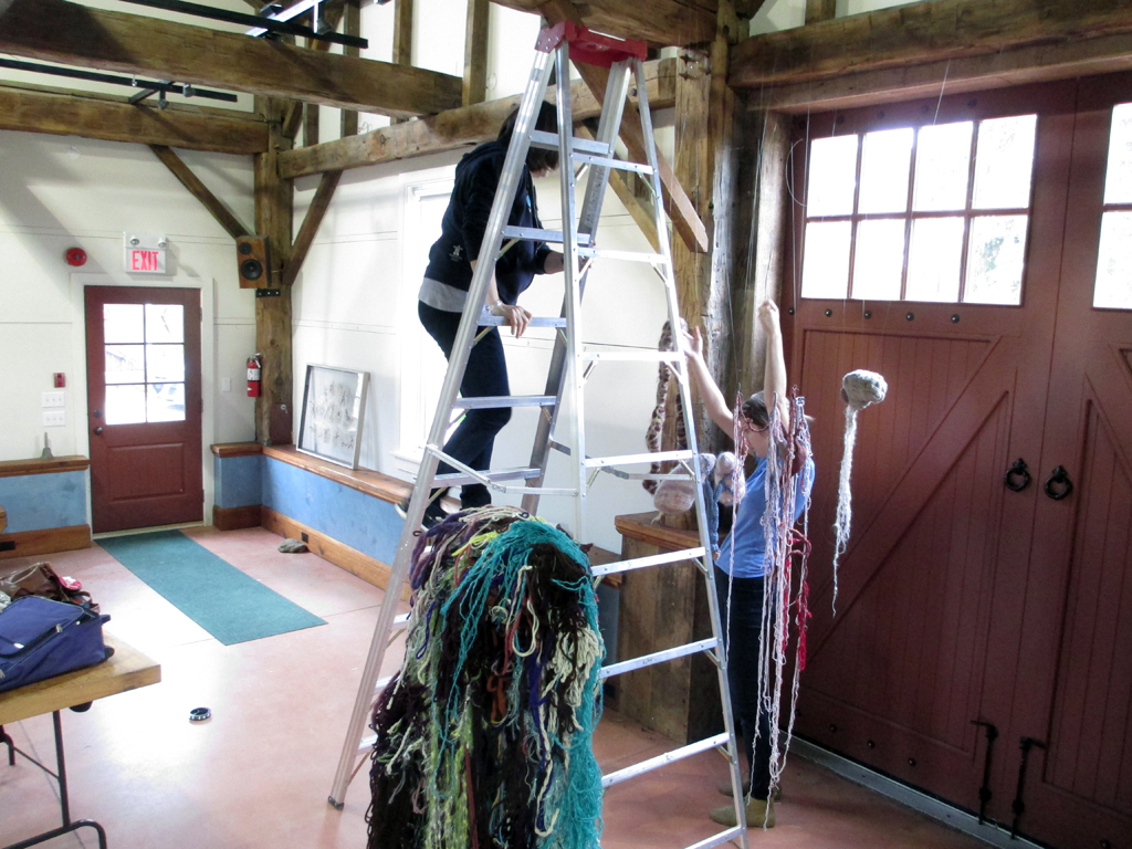 Jillian MacLachlan installing her artwork, De rerum natura, World of Threads Festival 2012.