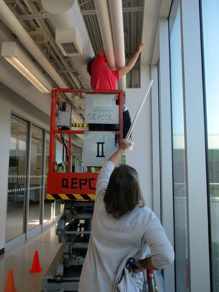 Festival installer: Heidi installing the Flow installation, World of Threads Festival 2023-24.