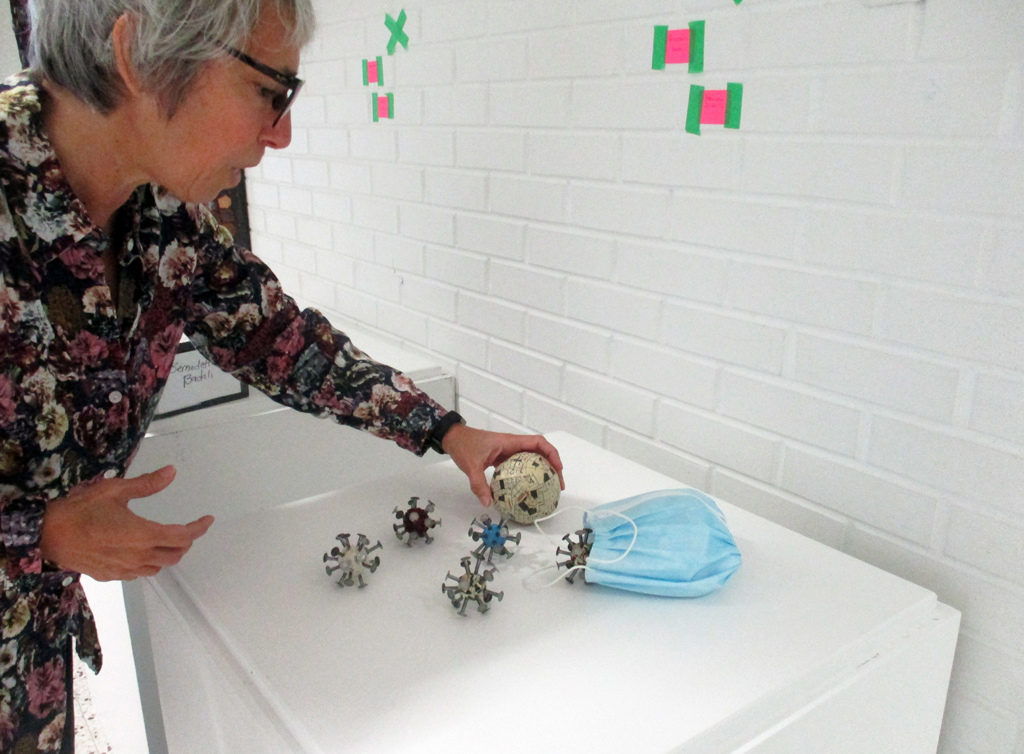 Bernadette Badali installing her work in the Covid Forever exhibition, World of Threads Festival.