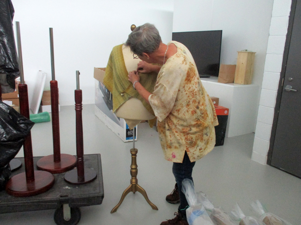 Artist: Miriam Kaufman, installing her work for Cat Walk III, World of Threads Festival 2023-24.