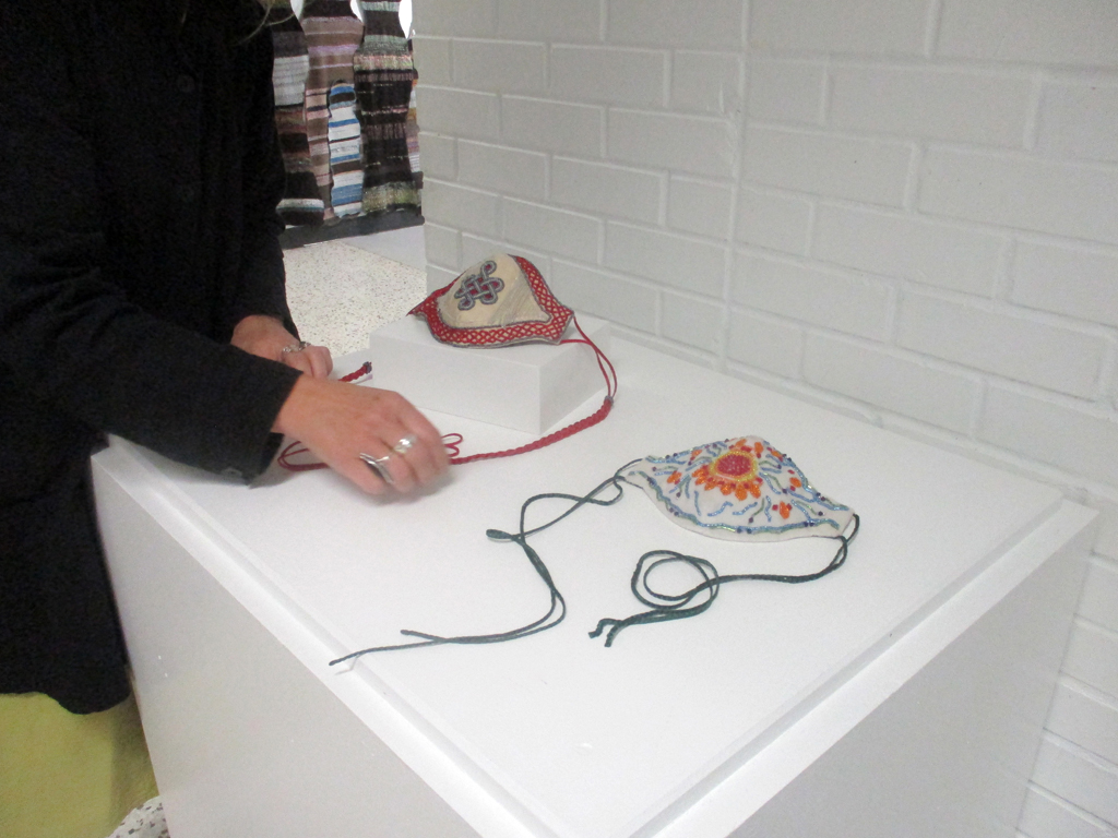 Tracy Gorman installing her work in the Covid Forever exhibition, World of Threads Festival 2023-24.
