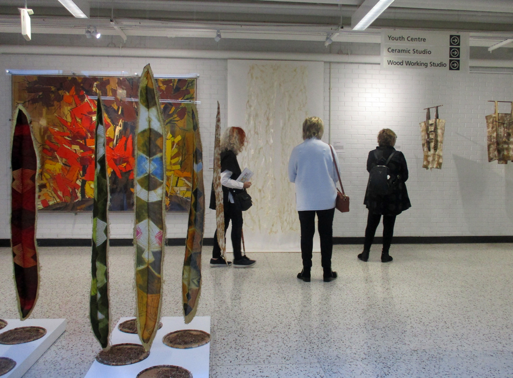 Visitors looking at the Peace installation, World of Threads Festival 2023-24.