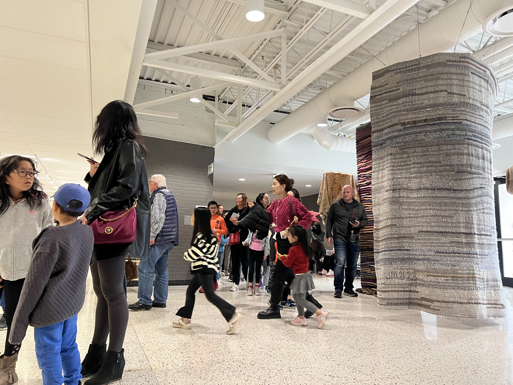 Visitors looking at the Time installation, World of Threads Festival 2023-24.