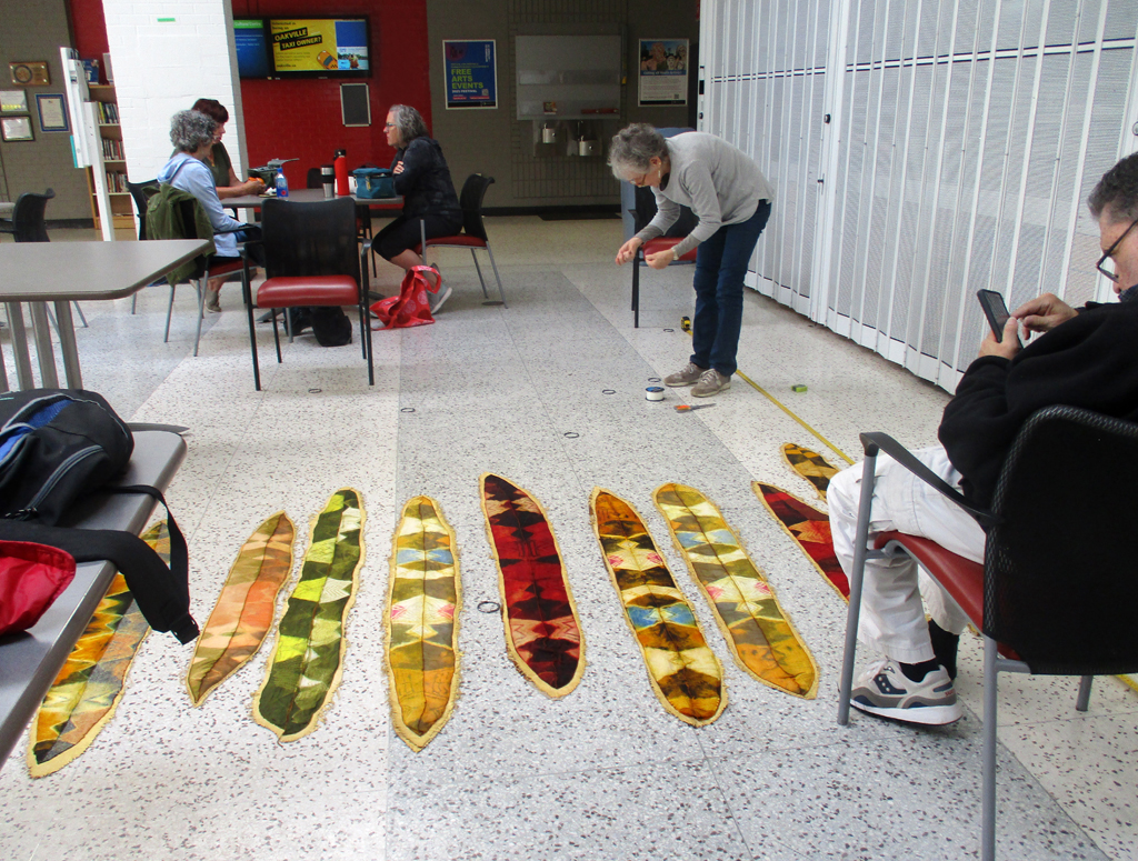 Artist: Joan Diamond preparing her work for installation, World of Threads Festival 2023-24.