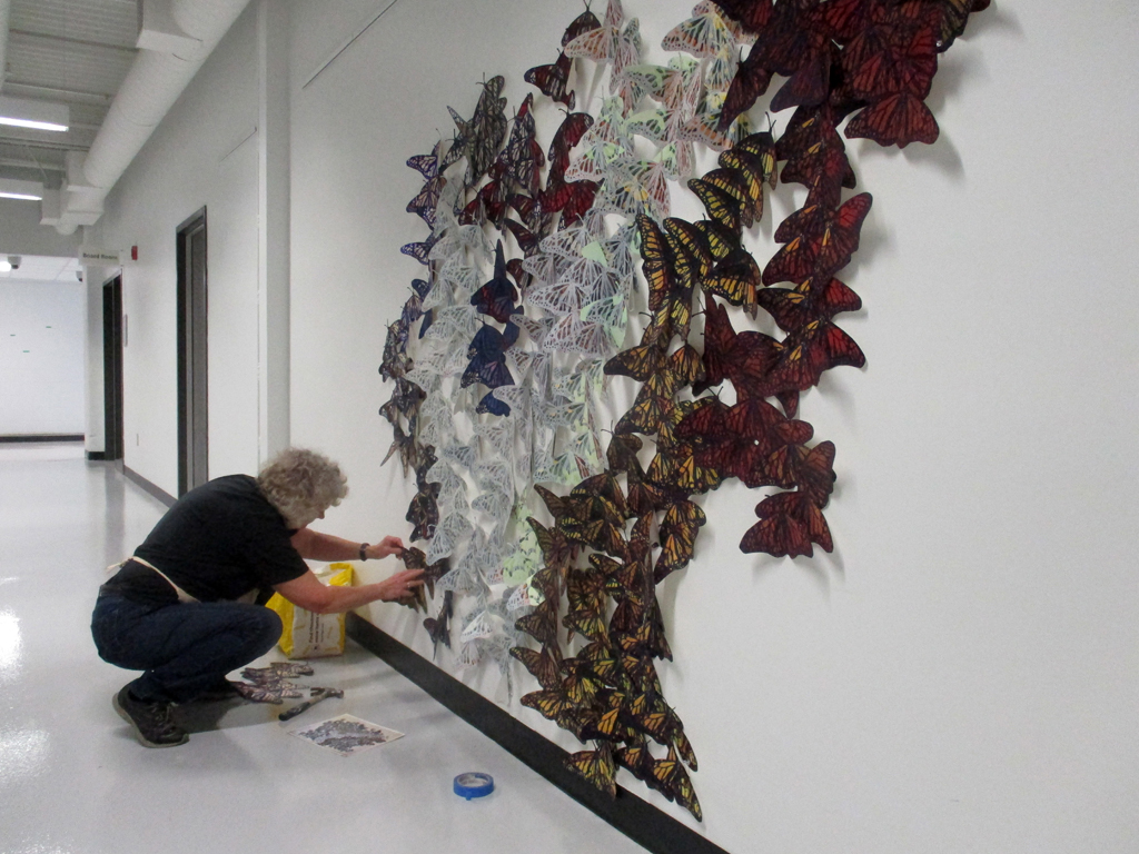 Artist: Lorna Livey installing her Safety in Number installation, World of Threads Festival 2023.