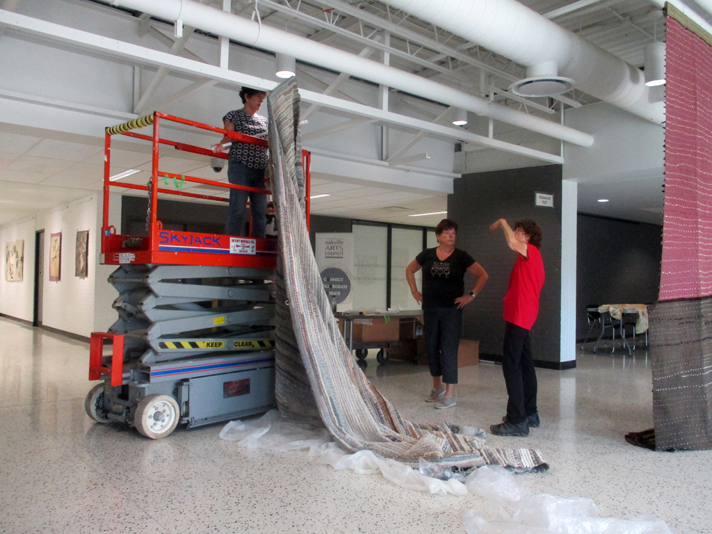 Festival installers: Carol, Freda and Margaret installing the Time installation, World of Threads Festival 2023-24.