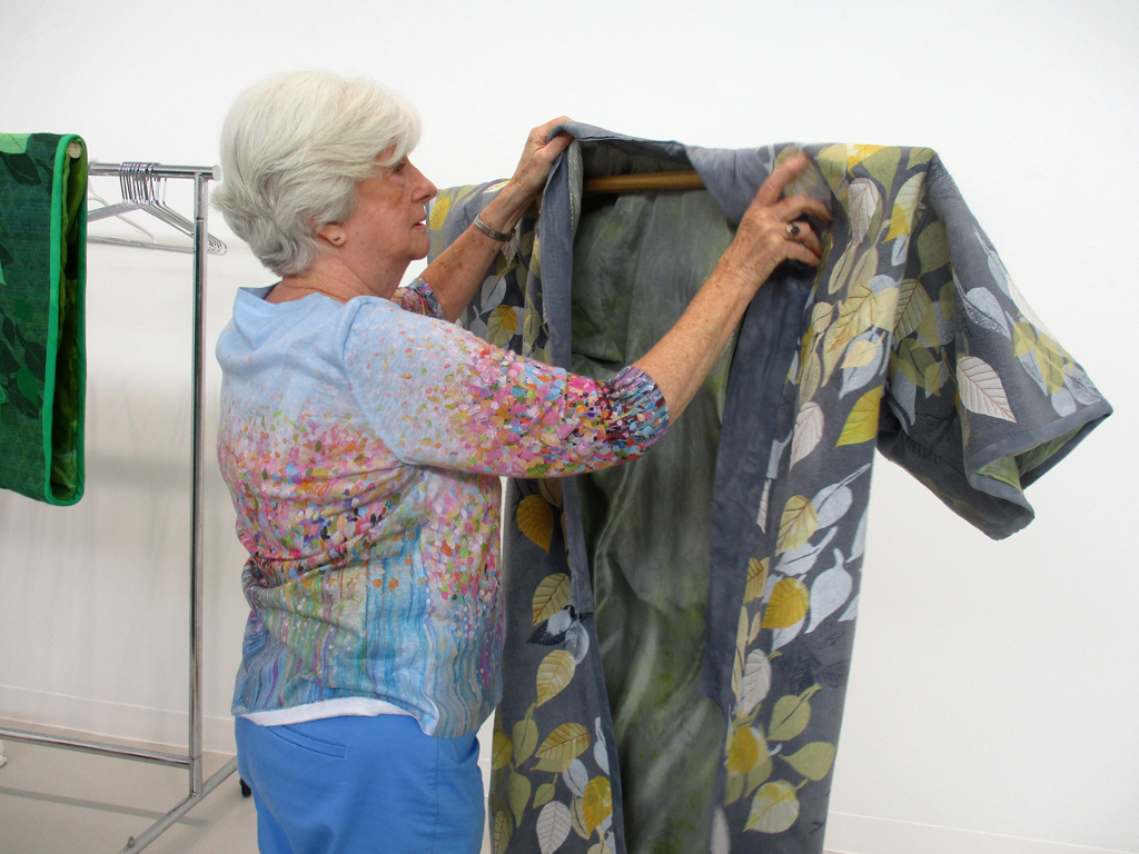Artist: Pat Burns-Wendland, installing her work for Cat Walk III, World of Threads Festival 2023-24.