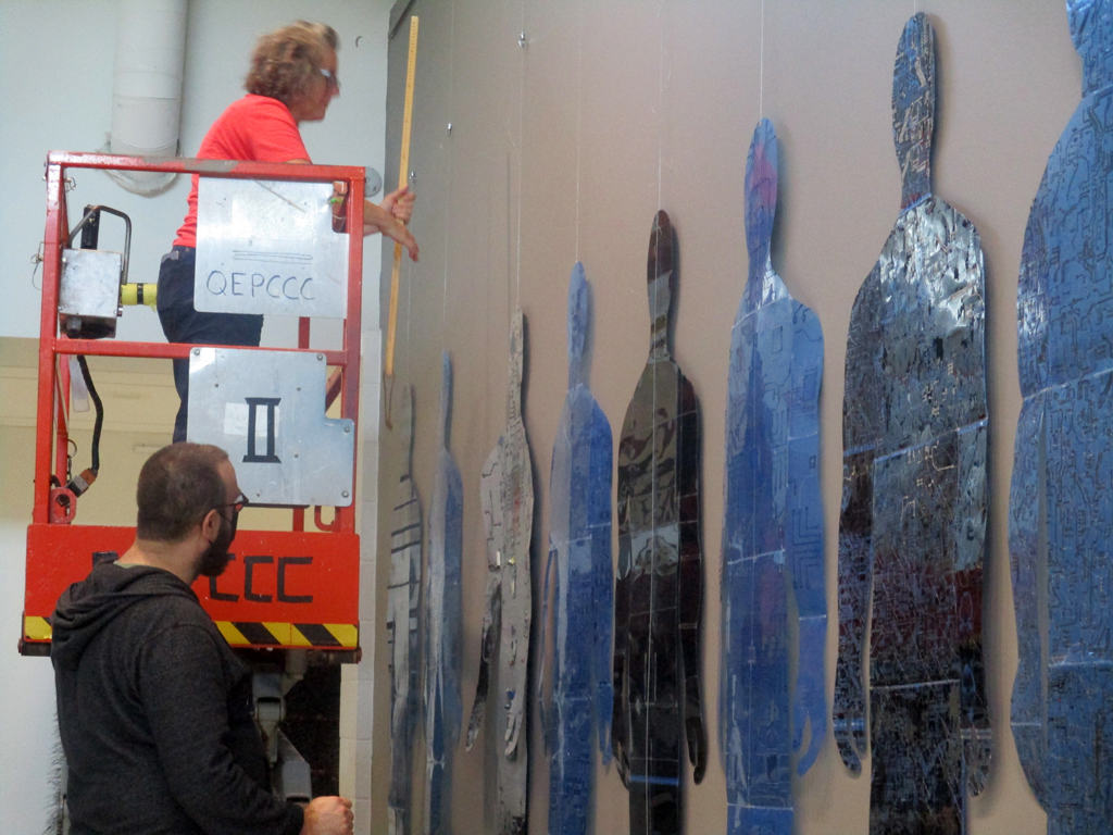 Festival Installer: Heidi, and Curator: Gareth, installing Homo Algorithmus, World of Threads Festival 2023-24.