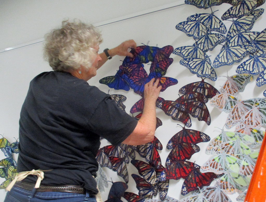 Artist: Lorna Livey installing her Safety in Number installation, World of Threads Festival 2023.