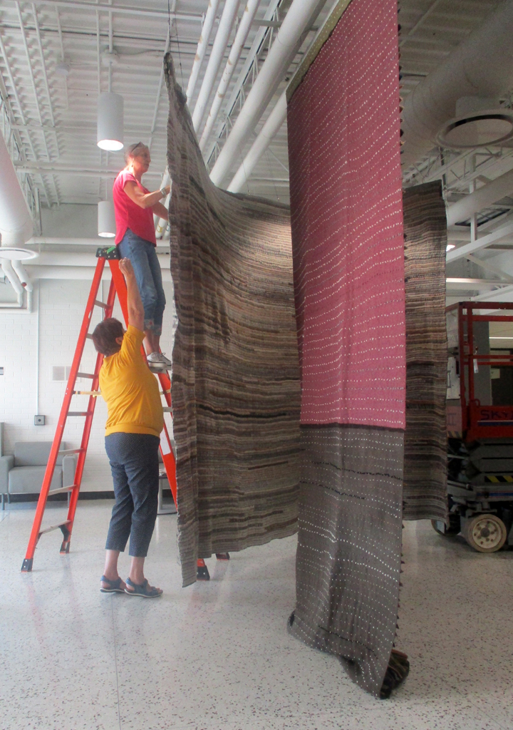 Festival installers: Freda and Caren installing the Time installation, World of Threads Festival 2023-24.