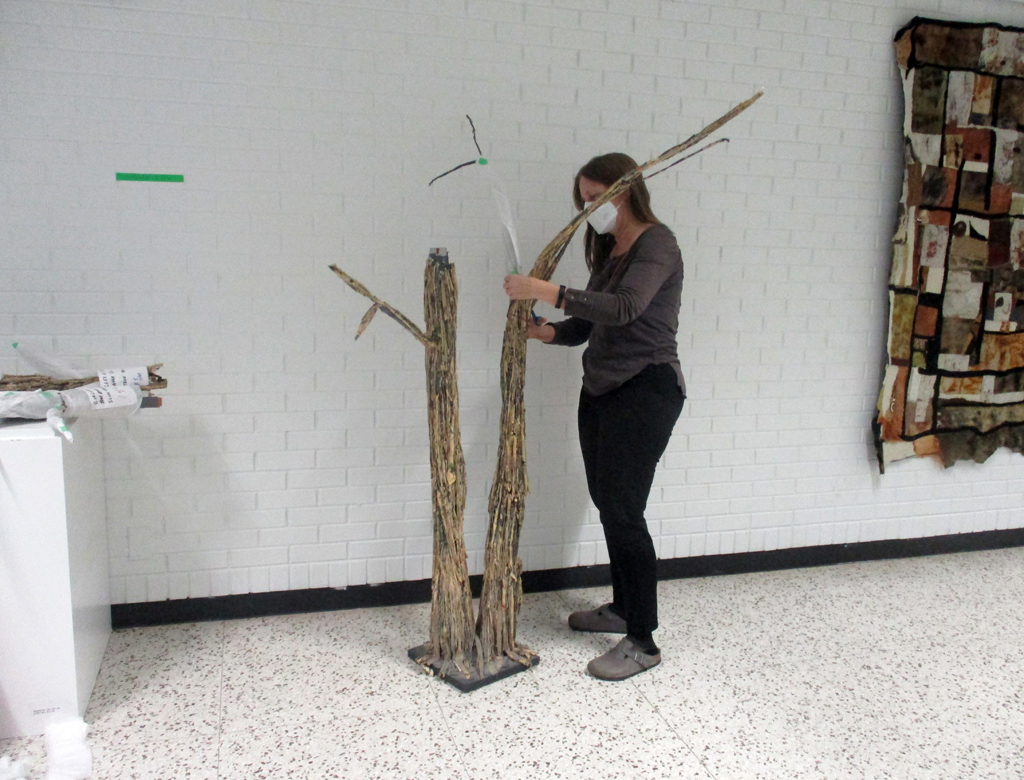 Artist: Barbara Cook: installing the Cycle of Life installation, World of Threads Festival 2023-24.
