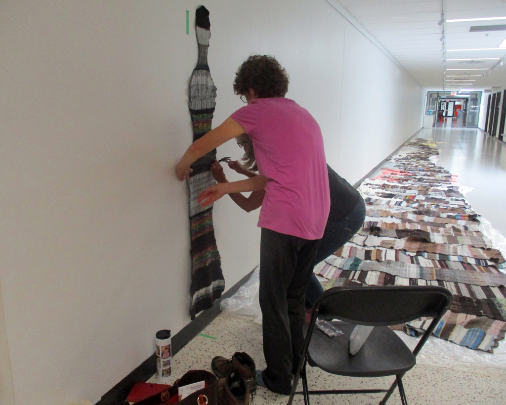 Festival Installer: Margaret and Artist: Carolyn Carson and installing The Ovine Conspiracy installation, World of Threads Festival 2023-24.