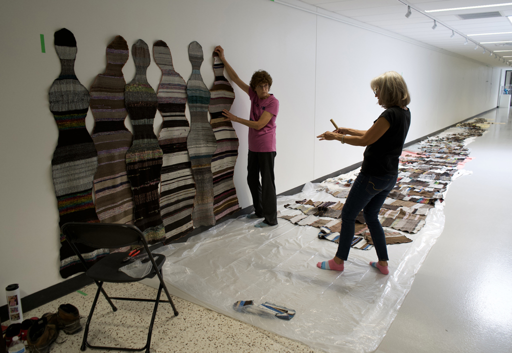 Festival Installer: Margaret and Artist: Carolyn Carson and installing The Ovine Conspiracy installation, World of Threads Festival 2023-24.